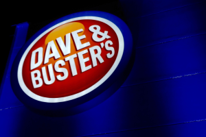 South Carolina lawsuit says Dave & Buster's games are illegal gambling. Dave & Buster’s illuminated storefront sign at night with red and blue logo branding on building exterior
