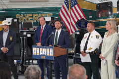 Florida Attorney General James Uthmeier announces results of a Southwest Florida illegal gambling crackdown alongside law enforcement officials, with seized gaming machines displayed during a press conference on gambling enforcement and payment processor scrutiny.