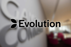 Evolution logo displayed at company office after UK Gambling Commission £4.75 million license review settlement