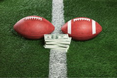 Two footballs and cash on field representing college football prediction market payouts. Coinbase blames Kalshi for Michigan market error and protects payouts customers