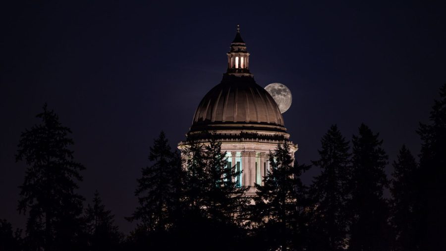 A government dome lit up at night