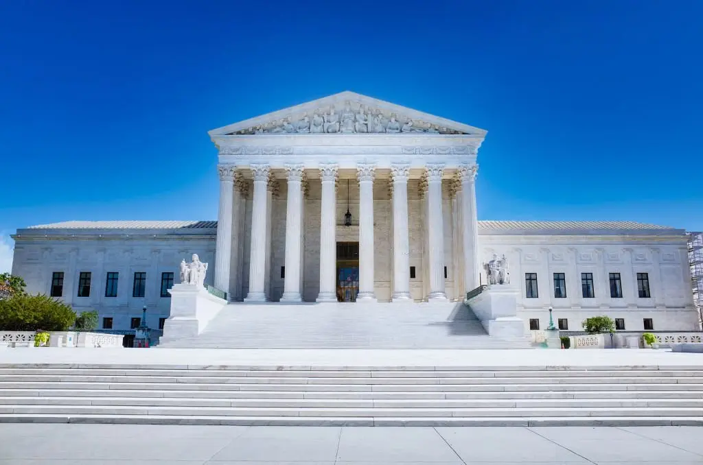 The exterior of the Supreme Court of the United States building in Washington, D.C., featuring white marble columns.
